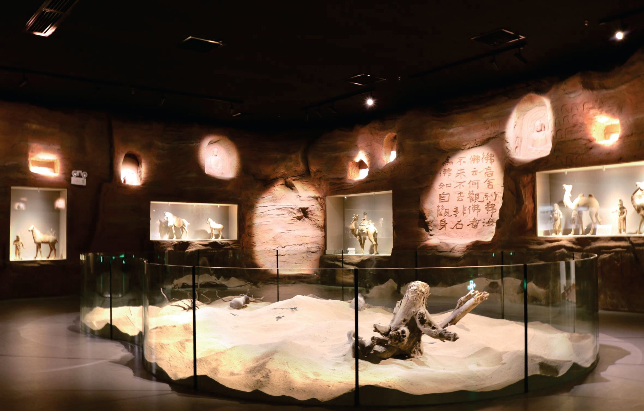 Exhibition lighting picking out objects and interpretive surfaces