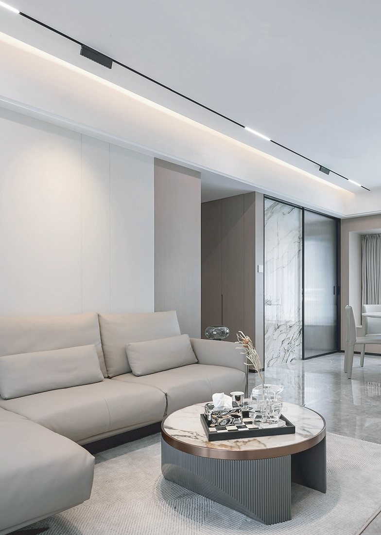 Magnetic track lighting above a living room